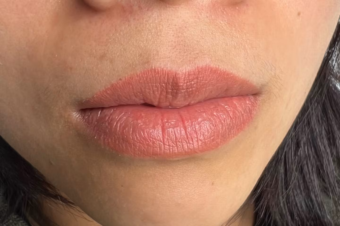 Aqua watercolor lip tattoo result, a sheer, natural-looking tint with soft, even color