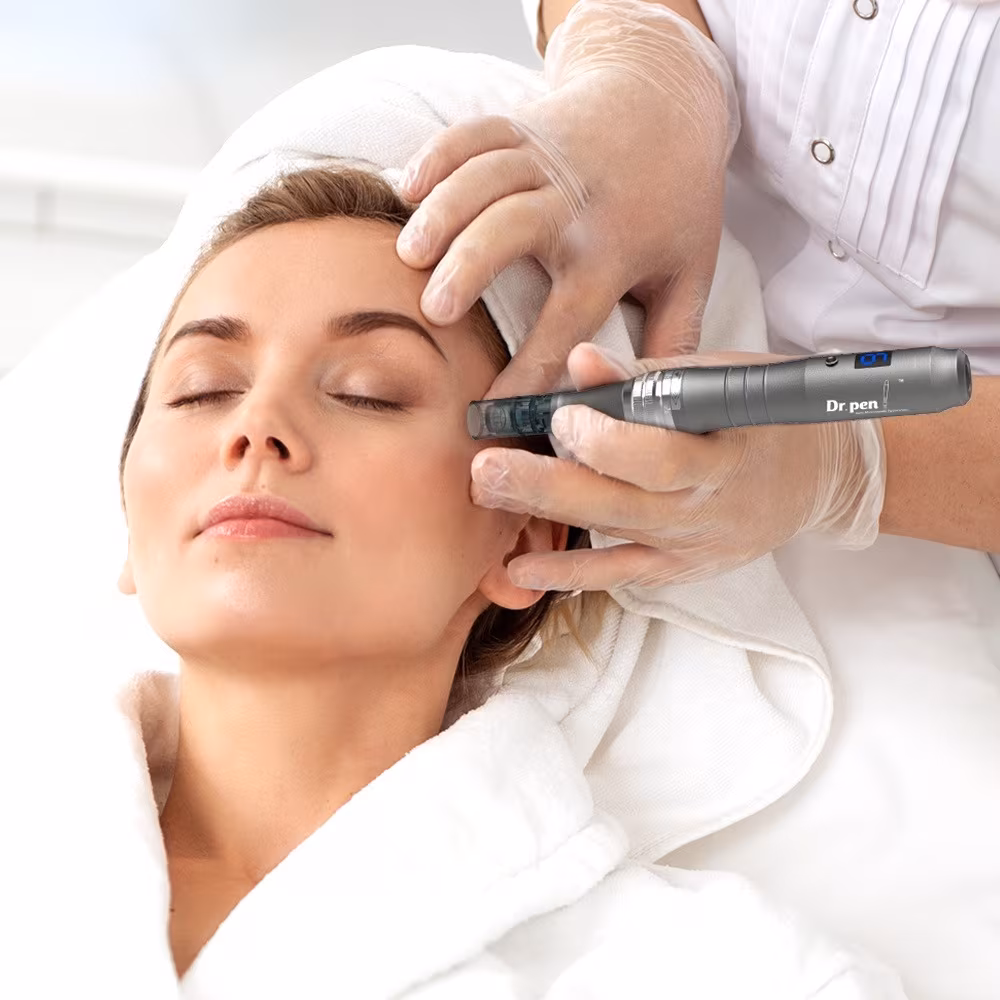 Microneedling pen treatment on a client’s temple and forehead