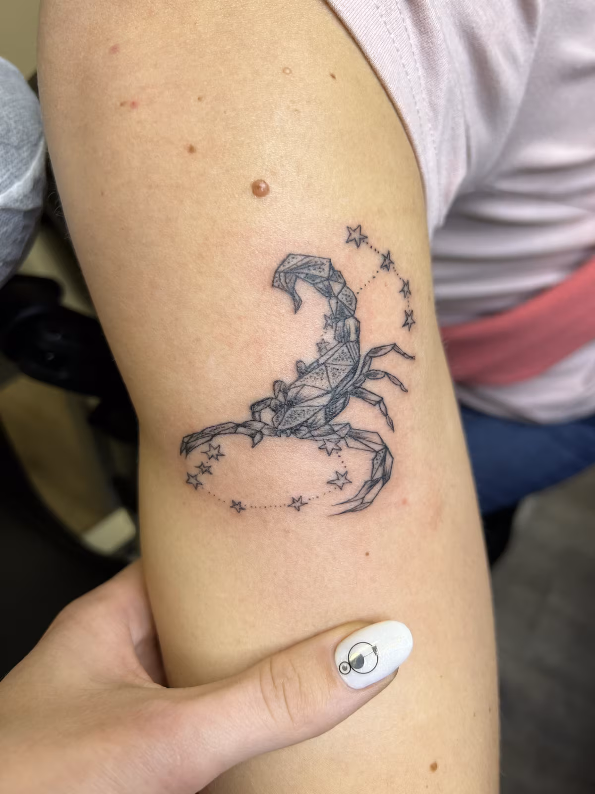 Minimalist fine-line tattoo with thin, clean lines and no shading