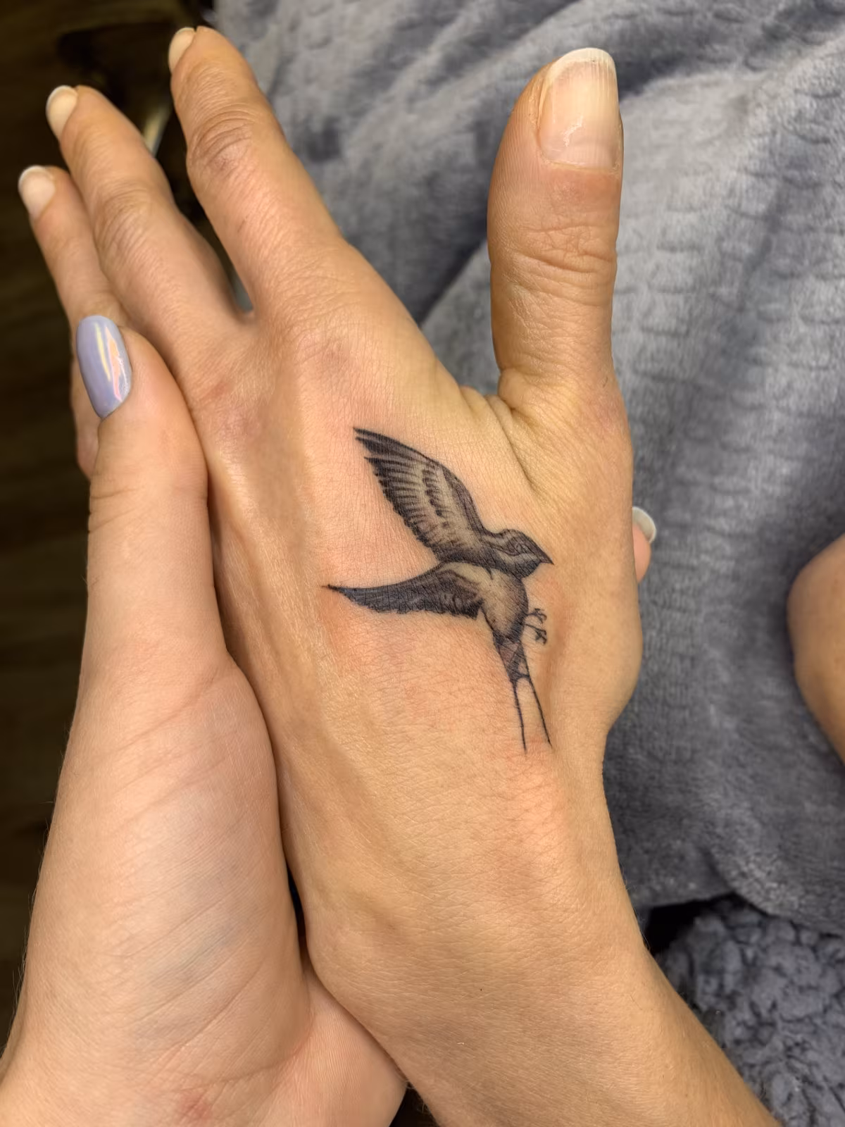 Small fine-line tattoo placement example in black ink